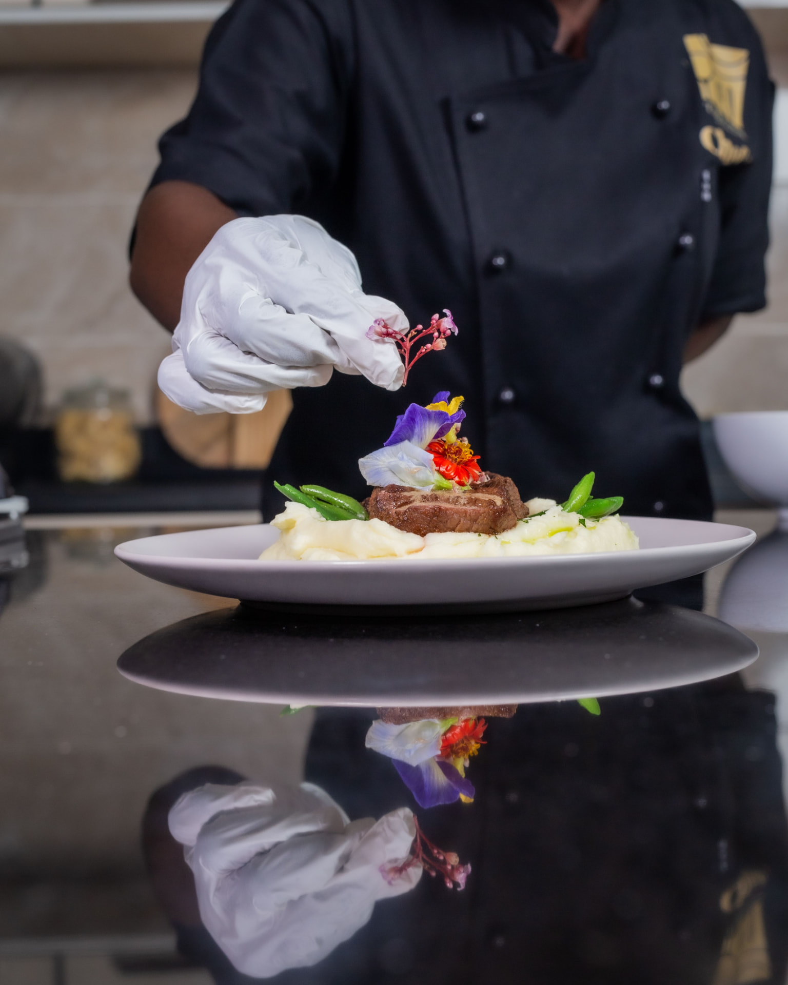 A private chef finishing a plated meal